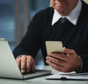 cropped-man-checking-messages-his-phone-office-e1726625942773